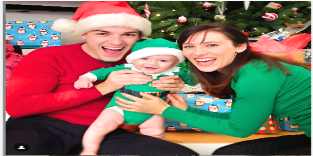 MatPat (wearing christmis dress of red colour and red cap) with his wife and son (wearing green dress like Santa), celebrating Christmas occasion