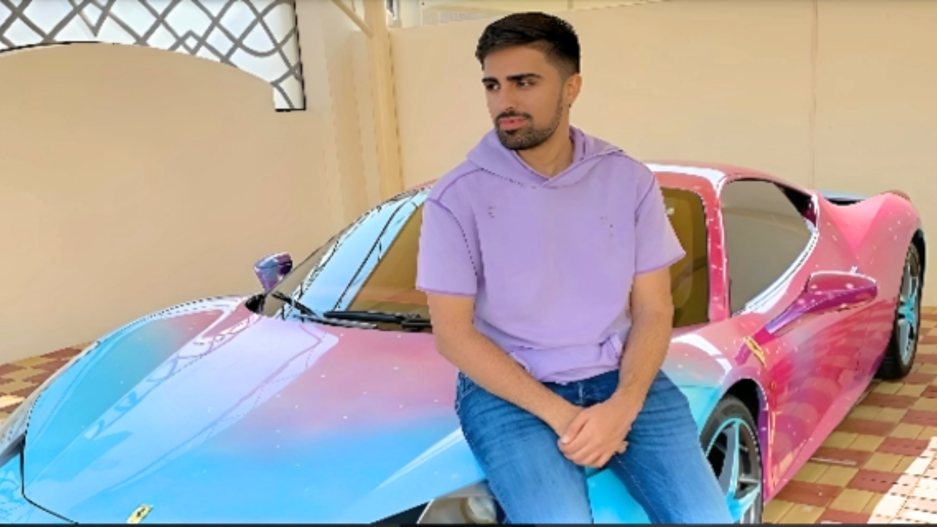 Mo Vlogs wearing purple color shirt and blue pant, smiling with car at background, depicting Mo Vlogs Net Worth: How Rich is YouTuber?