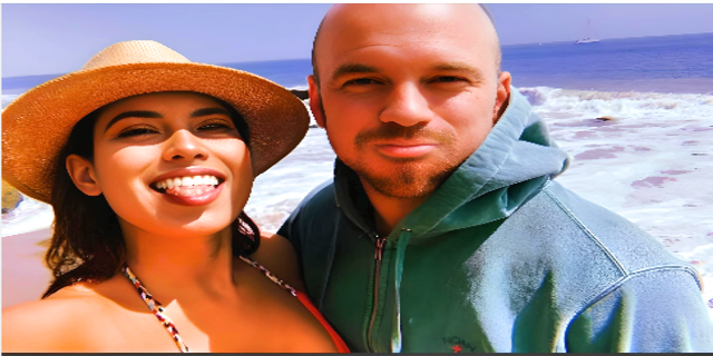 Sean Evans ( wearing blue hoodie), and his girlfriend Natasha Alexis Martinez (wearing top and hat), smiling with beach at background.