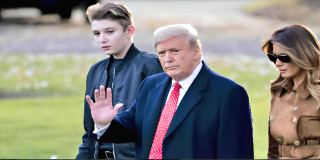 Barron Trump with his father Donald Trump and mother Melania Trump with greenery in background 